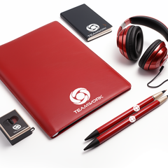 A red conference kit including a notebook, a notepad, a pair of headphones, a pen, and a paper clip holder, all with a white logo on them.