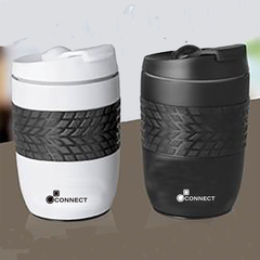 Two expresso flasks, one white and one black, with a tire pattern on the side, displayed on a table.