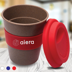 A bamboo flask with a red lid, placed on a table with the brand 'aiera' visible on the flask.