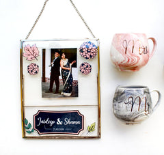 A gift hamper set with a gold-rimmed photo frame and a set of two ceramic mugs, one with 'Mr.' and the other with 'Mrs.