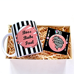 A custom-printed mug with black and white stripes and pink text that reads 'BOSS BABE FUEL', accompanied by a matching badge with a different design, both placed on a bed of confetti.