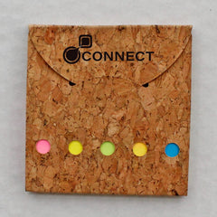 A pocket-size cork book with various sizes of colorful post its on the cover, with the brand 'CONNECT' visible.