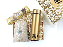 A designer-corrugated gift box with a temperature display flask, Ferrero Rocher, and a pouch of gourmet chocolates.