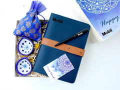 Hamper contains a branded vegan leather diary, a set of Jaipur blue pottery handmade diyas, and a pouch of gourmet biscotti

All in a designer-branded gift box
