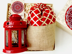 The hamper contains a pouch of trail mix and a vintage lantern. 
